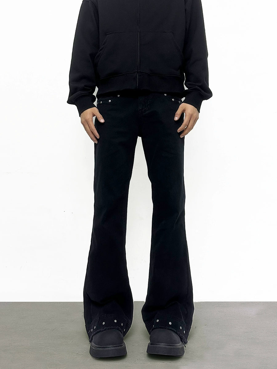 Person wearing a black outfit with studded details on a white background