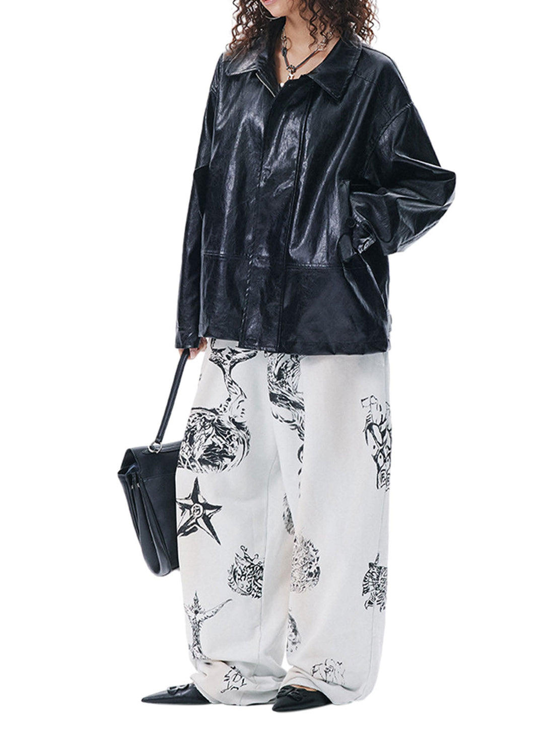 Person wearing a black leather jacket and white pants with black patterns on a white background