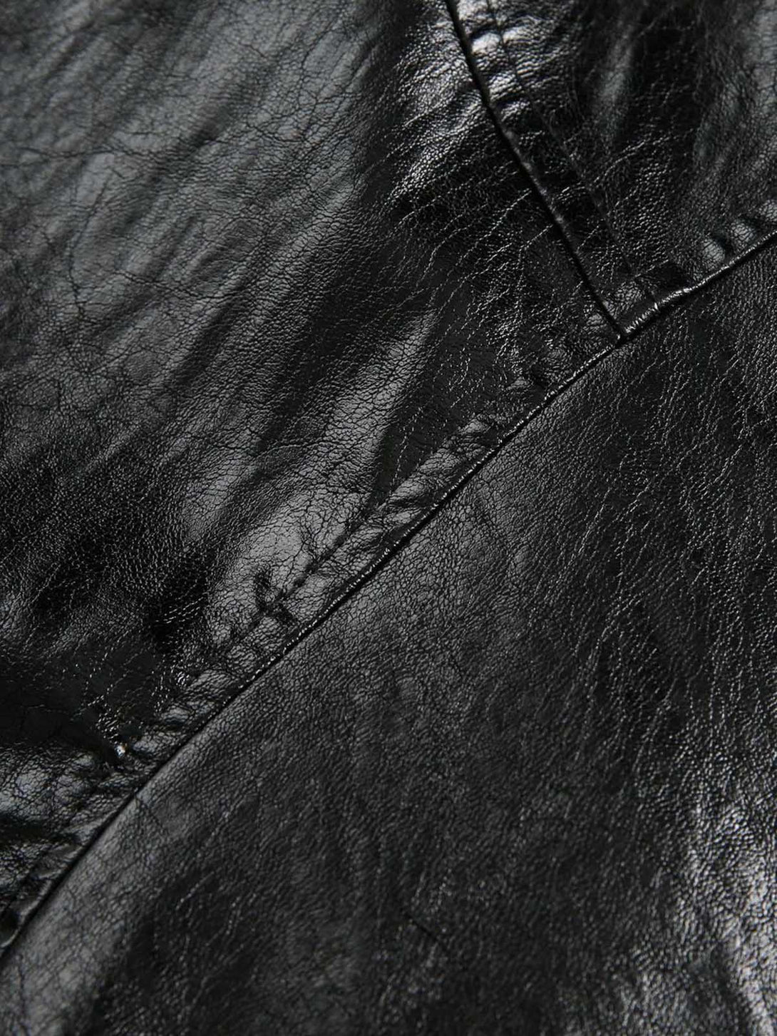 Close-up of black leather texture with stitching details