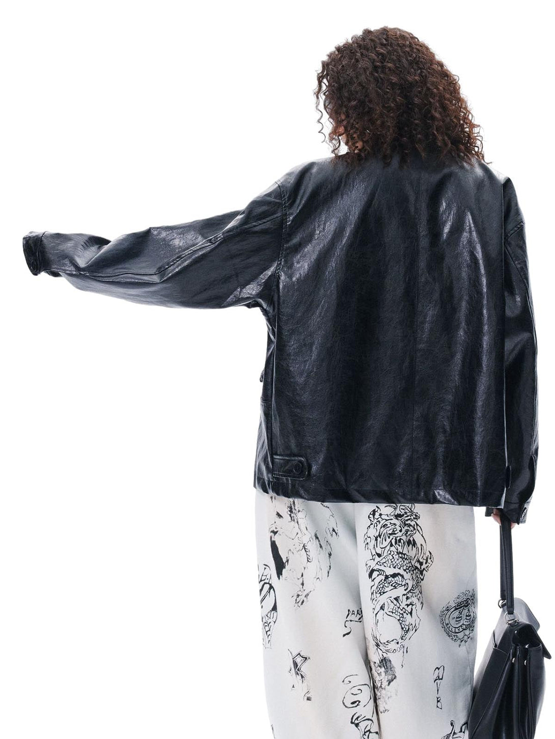 Person wearing a black leather jacket with a white background