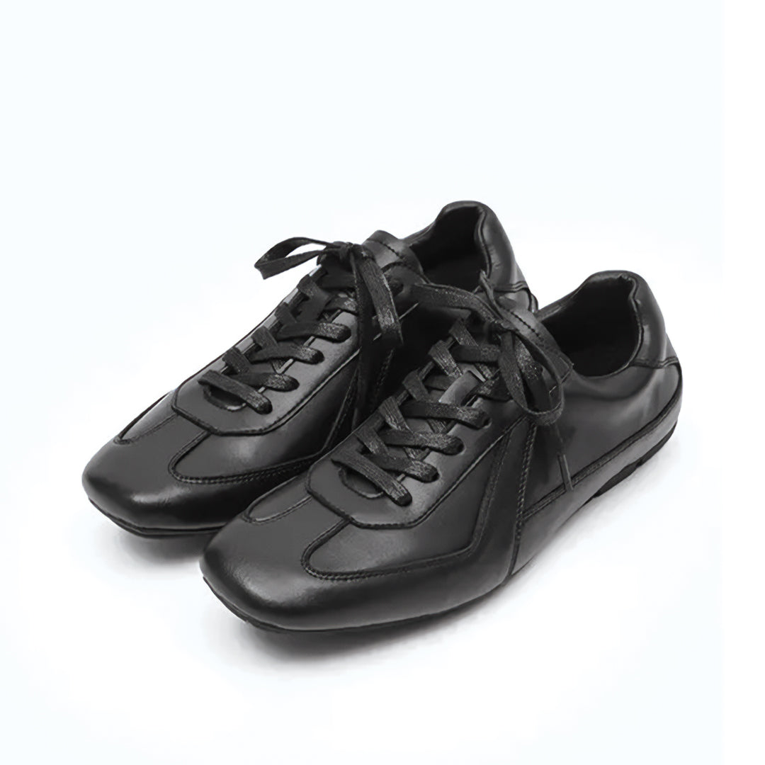 Pair of black leather shoes on a white background