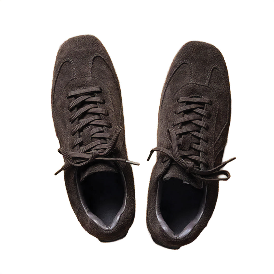 Pair of brown suede sneakers on a white background