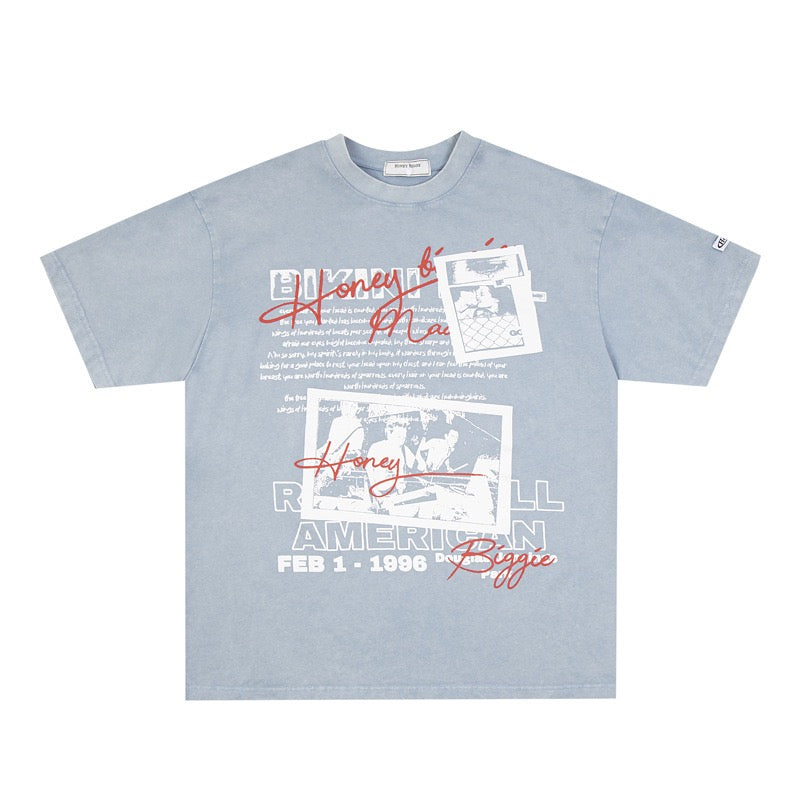 Light blue t-shirt with graphic design and text on a white background